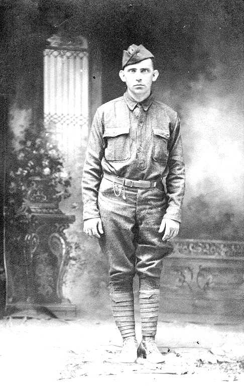 Black-and-white full-length studio portrait attributed to George William Maddox standing in a World War I U.S. Army uniform.